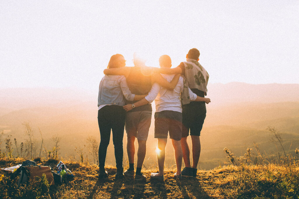 Family hugging overlook a sunset