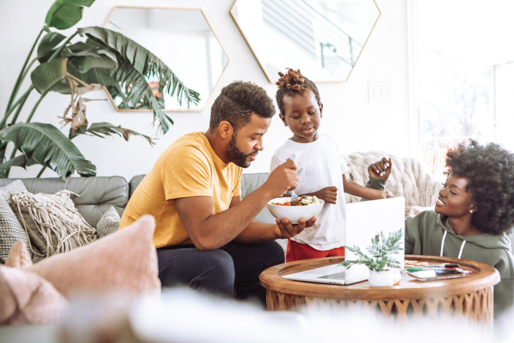 Two parents with life insurance having breakfast with their child