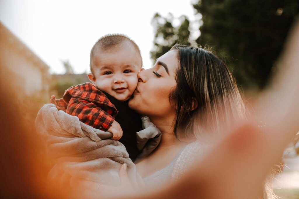 Mother kissing her child